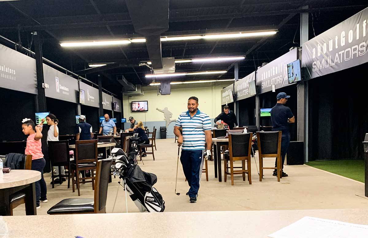 Inside of NJ Indoor golf. Showing tables and play stations